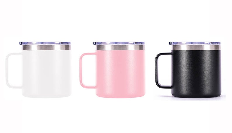 May include: Three stainless steel travel mugs with lids. The mugs are white, pink, and black.