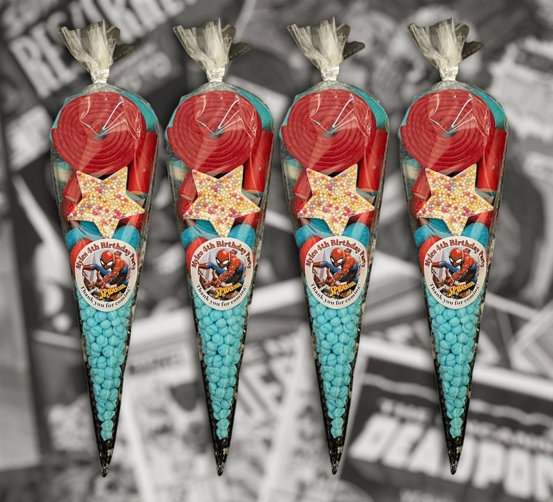 May include: Four cone-shaped sweet bags filled with blue, red, and white candies. Each bag features a star-shaped sweet and a red spiral sweet. Each bag has a label with a Spider-Man graphic and text, perfect for a birthday party.