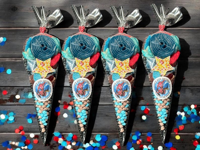 May include: Four cone-shaped party favor bags filled with colourful sweets. Each bag features a large blue sweet, star-shaped sweets, and a sticker with a Spider-Man graphic and the text "[Name]'s 8th Birthday Party".