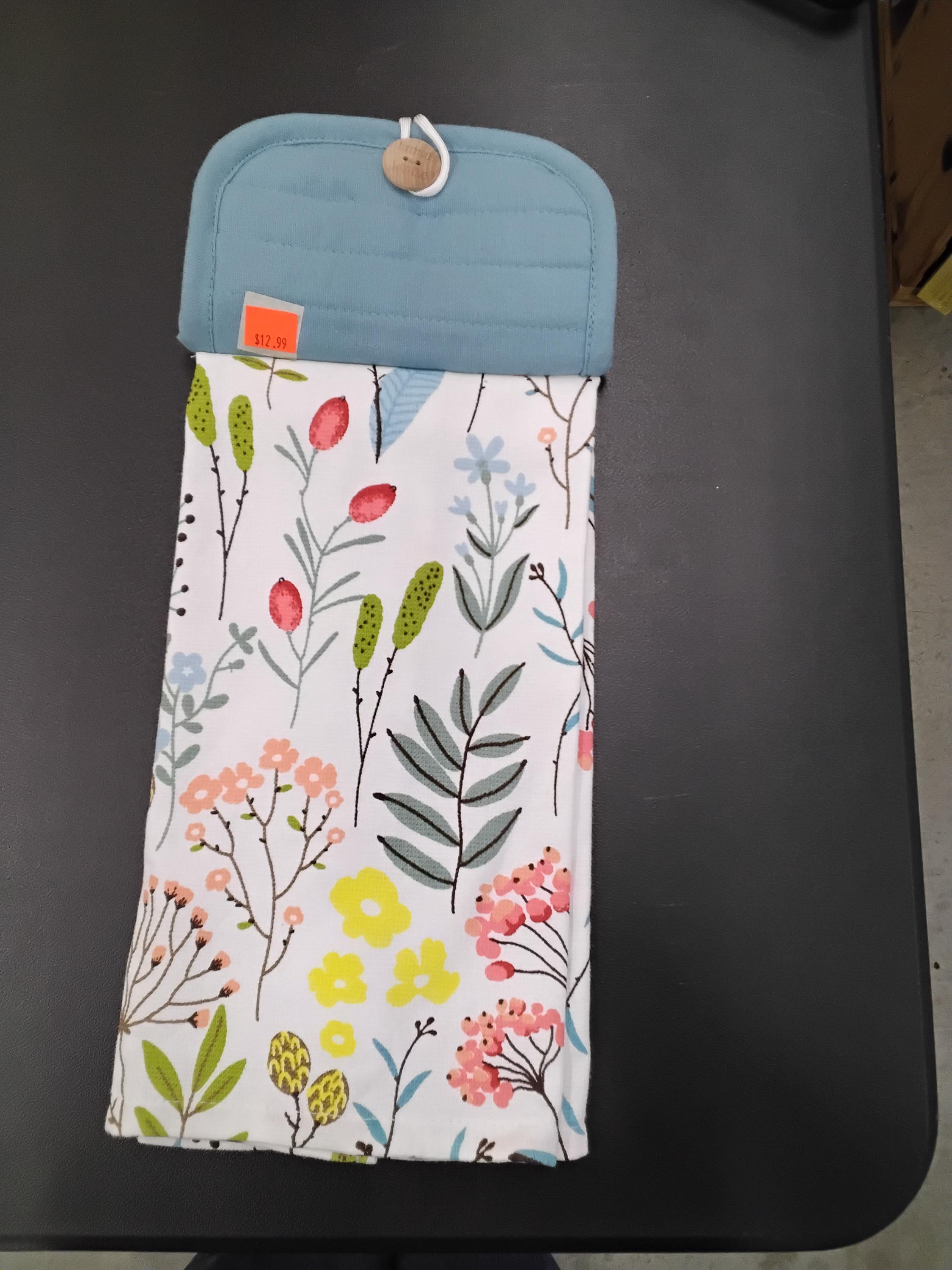 light blue potholder,with flowers and greenery on towel