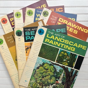 May include: A collection of vintage art instruction books with titles like "The Art of Landscape Painting" and "Drawing Trees." The books feature colorful covers with illustrations and text, some with price stickers.
