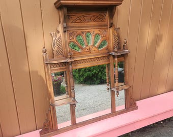 Miroir mural ancien en bois avec détails sculptés et petites étagères