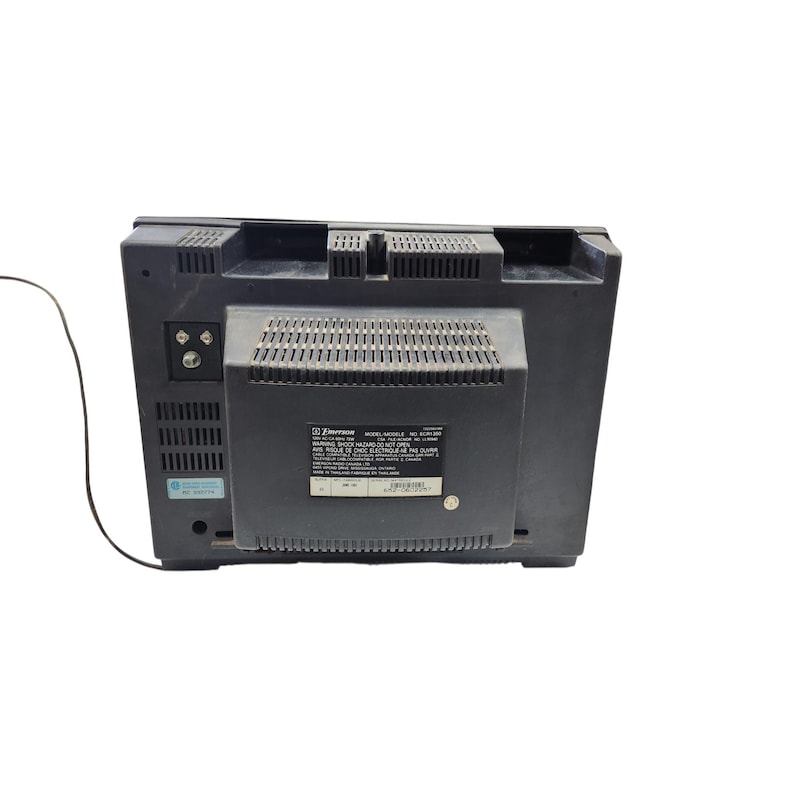 May include: A black Emerson television set, viewed from the back. The television has a rectangular shape with a dark grey finish. The back features ventilation slots and a label with model information.
