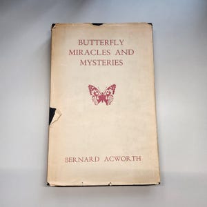 May include: A vintage book titled "Butterfly Miracles and Mysteries" by Bernard Acworth. The cover features a red butterfly illustration.