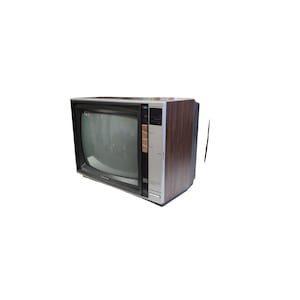 May include: Retro television set with a wood-effect cabinet and a black screen surround. The front panel is silver with black control buttons. The TV has a classic design, ideal for home decor or a collector's item.