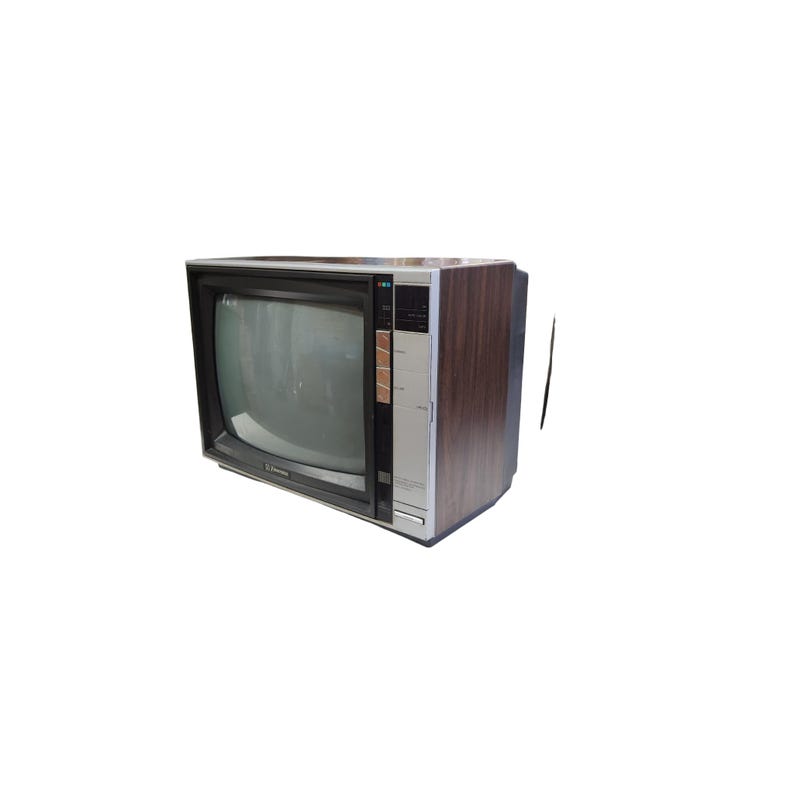 May include: Retro television set with a wood-effect cabinet and a black screen surround. The front panel is silver with black control buttons. The TV has a classic design, ideal for home decor or a collector's item.