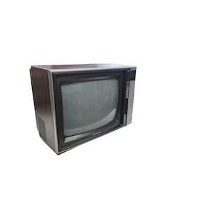 May include: A retro television set with a wood-effect casing and a dark screen. The TV has a silver trim around the screen and a control panel on the right. The brand name is visible on the bottom left of the screen.