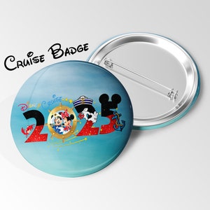 May include: A round Disney Cruise 2023 badge with a blue background and a silver pin back. The badge features Mickey and Minnie Mouse, a ship's wheel, and the text "Disney Cruise" and "2023". The words "Cruise Badge" are above the badge.
