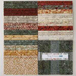 May include: A fabric bundle featuring a variety of patterned cotton squares in shades of green, brown, tan, and red. The fabrics have floral and abstract designs. The bundle is labeled "Changes in Seasons".
