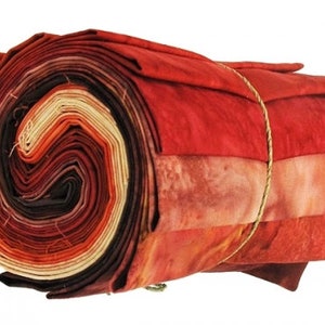 May include: A roll of fabric in shades of red, orange, and brown. The fabric is tied with twine and has a mottled, tie-dye effect.