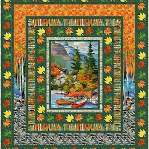 May include: A green, orange, and yellow quilt with a central image of a mountain scene with two canoes in a lake. The quilt is framed with a border of maple leaves.