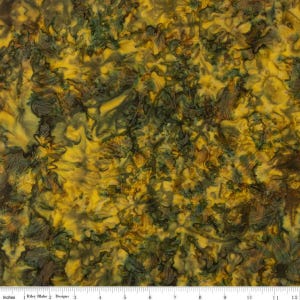 May include: A close-up of fabric with a batik-style pattern. The fabric features a blend of yellow, green, and brown hues, creating a textured, organic appearance. The design includes leaf-like shapes and swirling patterns. The image includes the text "Inches" and "Riley Blake Designs".