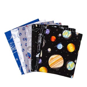 May include: A collection of six fabric pieces with space-themed designs. The fabrics feature planets, rockets, and NASA logos in various colors, including blue, gray, and black. The fabrics are arranged in a fan shape, showcasing the different patterns.