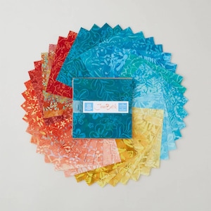 May include: A collection of colorful batik fabric squares arranged in a circular pattern. The squares feature floral and abstract designs in shades of red, orange, yellow, teal, and blue. The center shows a stack of squares with the text "Java Batik".