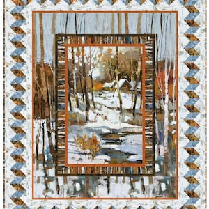 May include: A quilted wall hanging featuring a winter landscape scene. The central image depicts a snowy forest with a cabin. The quilt has a geometric border with blue, brown, and white triangles, and a white background.