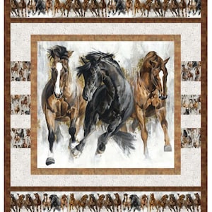 May include: A quilt featuring a central image of three horses in motion, painted in shades of brown and black against a white and gray background. The quilt has a brown border with running horse patterns.