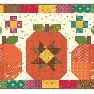 May include: A patchwork quilt block featuring three orange pumpkins with green stems and leaves. The pumpkins are surrounded by small squares of various fabrics in shades of orange, yellow, green, brown, and pink. The background is a cream color with small white dots.
