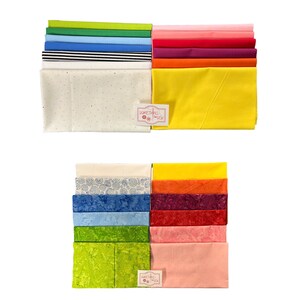 May include: Two stacks of fabric squares in various colors and patterns, including white with black stripes, white with colorful dots, blue with white swirls, and solid colors like green, yellow, orange, pink, and red. The fabric squares are arranged in a rainbow pattern. The stacks are labeled "Something to Sew".