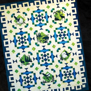 May include: A quilt pattern featuring a geometric design with a white background, blue and green squares, and a variety of nature-themed silhouettes. The quilt size is 82" x 100".