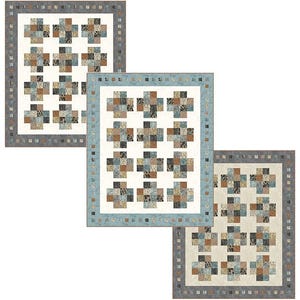 May include: Three quilts with a patchwork design. Each quilt features a white background with a pattern of cross-shaped blocks in shades of brown, blue, and gray. The quilts have borders in coordinating colors.