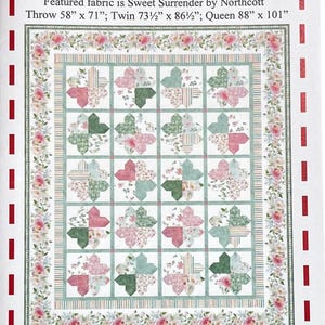 May include: A quilt pattern called "Heart Flowers" featuring a floral design in pink, green, and white. The pattern is for a 10-inch tile pack and includes instructions for making a throw, twin, or queen-sized quilt.