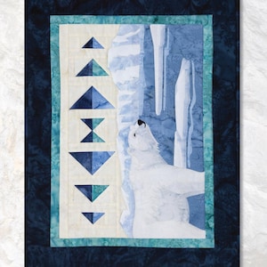 May include: A fabric art piece titled "Polar Bear" from "The Last Frontier Collection." The artwork features a white polar bear against a blue and white icy backdrop. The piece includes geometric shapes and is framed at 17.5" x 23.5".