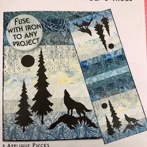 May include: Applique set featuring a wolf and trees design. The set includes eight applique pieces, with measurements provided in inches. The design includes silhouettes of wolves, trees, and a moon, with the text "Fuse with iron to any project".