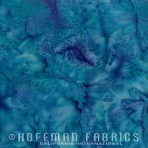 May include: Abstract blue and purple batik fabric with a swirling, marbled pattern. The fabric has a soft, flowing texture and is perfect for quilting, apparel, and home decor projects.