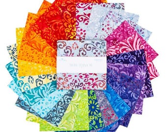 May include: A stack of square fabric swatches arranged in a circular fan pattern, featuring a spectrum of colours including red, orange, yellow, green, blue, and purple. Each piece has a batik-style floral pattern and pinked edges with a central band.