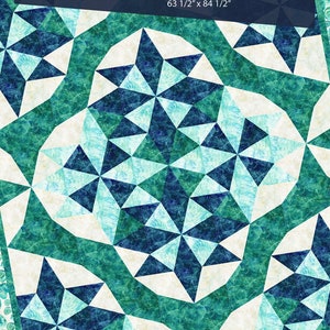 May include: A quilt pattern called "Reflections" by Tamarinis, featuring a geometric design of teal, blue, and white triangles. The quilt is 63 1/2 inches by 84 1/2 inches.