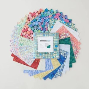 May include: A collection of fabric swatches arranged in a circular pattern. The swatches display various patterns, including polka dots, plaid, and floral designs, in a range of colors such as red, blue, green, and yellow. A square package with the text "Senartex" is in the center.