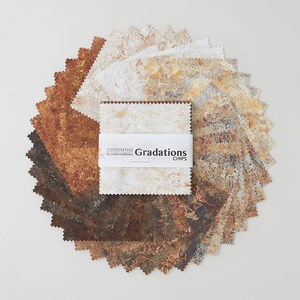 May include: A collection of 12 fabric squares in a variety of brown, beige, and gray tones with a mottled, textured appearance. The squares are arranged in a circle with a label in the center that reads "Stonehenge Gradations Chips by Linda Ludovico".