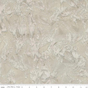 May include: A fabric with a textured, mottled appearance. The pattern features a mix of light beige and off-white tones, creating a subtle, organic design. The fabric has a soft, almost watercolor-like quality, with a hint of a marbled effect.