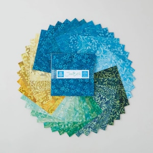 May include: A collection of batik fabric squares in shades of blue, green, and yellow arranged in a circular pattern. A square bundle of fabric is in the center, with the text "Java Batik" on the label. The fabric has floral patterns.