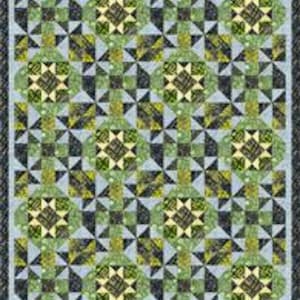 May include: A patchwork quilt with a repeating geometric pattern. The quilt features squares and starburst designs in shades of green, black, and yellow on a light blue background. The quilt has a dark gray border.