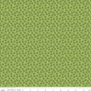 May include: Green fabric with a repeating pattern of small, dark green dinosaur footprints.