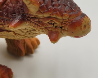 Vintage Ankylosaurus Dinosaur figure, brown and tan coloring with a spiky back and tail, heavy figure