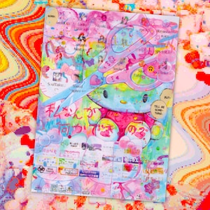 May include: A colorful illustration featuring a cartoon character with a large bow, surrounded by various text elements and a pair of pink scissors. The artwork has a vibrant, layered aesthetic with Japanese text and other graphic details.