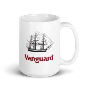 May include: White ceramic mug featuring a black line drawing of a tall ship with multiple masts. The word "Vanguard" is printed in red below the ship illustration. The mug has a curved handle.
