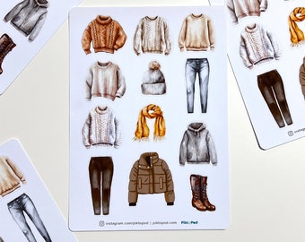 May include: A collection of watercolor stickers featuring various fall and winter clothing items. The stickers include sweaters, jeans, a beanie, a scarf, a jacket, and boots. The color palette consists of neutral tones like brown, gray, and beige.
