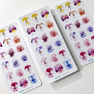 May include: Three sheets of stickers featuring watercolour illustrations of pansies in various colours. Each sheet has 20 stickers and includes the text "Pikt:Ped | piktpod.com".