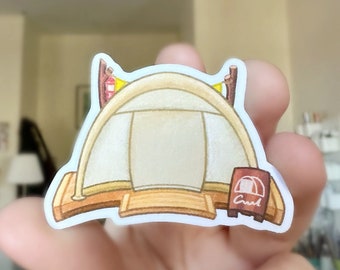 May include: A sticker featuring a cartoon illustration of a tent with a brown wooden base and a beige canvas. The tent has a rounded top and is flanked by two brown posts with yellow and red accents. A small sign reads "Creek".