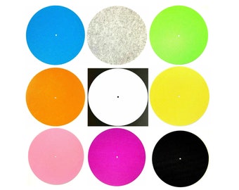 May include: Nine colorful turntable slipmats in a grid pattern. The mats are in various colors, including blue, gray, green, orange, yellow, pink, magenta, and black. A white mat is in the center. Each mat has a small center hole.