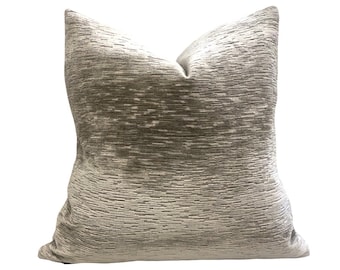 May include: A gray and white patterned throw pillow with a soft, textured fabric.