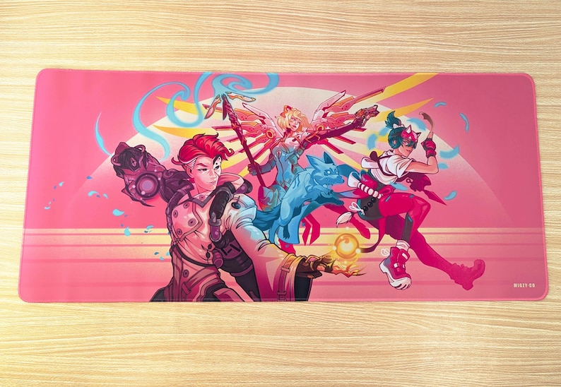 A pink mouse pad featuring three video game characters. The center character is glowing with light and holding a staff. The character on the right is striking a pose with a weapon. The character on the left is holding a glowing orb.
