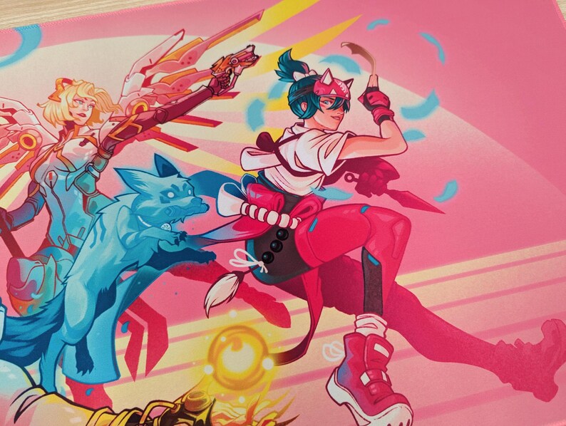 The right character has her hair in a ponytail and a headband with cat ears. She’s holding a paper with one hand and a knife with the other.