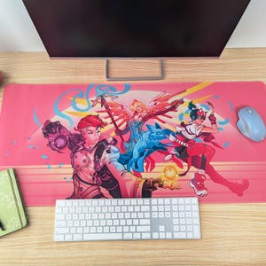A top-down image of the desk mat, used as a mouse pad on a desk. There’s a keyboard, mouse, and monitor around it.