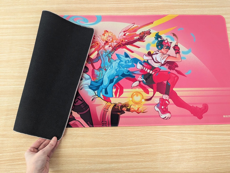 Someone is holding the mouse pad so you can see the bottom and top of it. The bottom is black rubber and has a grippy texture.