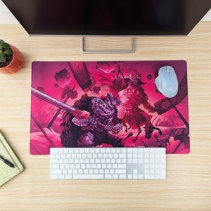 May include: A pink and black gaming mouse pad with a fantasy illustration of two figures fighting with swords. The figures are surrounded by a pink and white background with a variety of details.