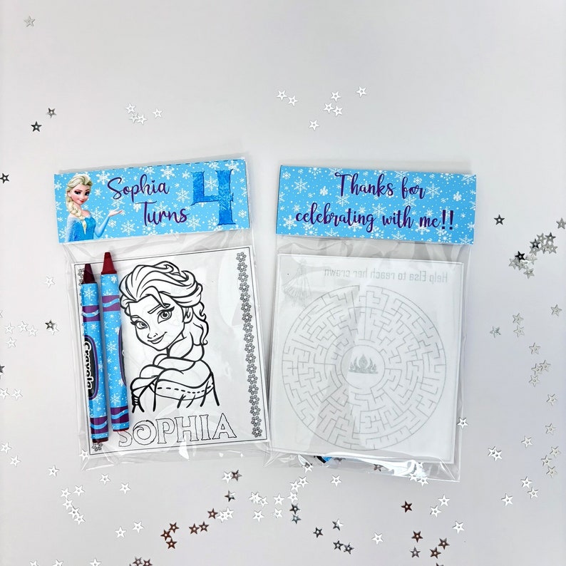 May include: Two Frozen-themed party favour bags. One bag has a colouring page of Elsa with two crayons. The other bag has a maze with the text "Help Elsa reach the castle!" and a thank you tag that says "Thanks for celebrating with me!!".